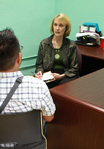 Melinda interviewing a client in a private office.