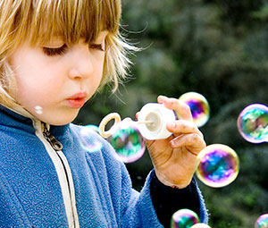 young girl blowing bubbles