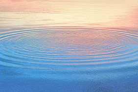 ripples on water with peach colored reflections