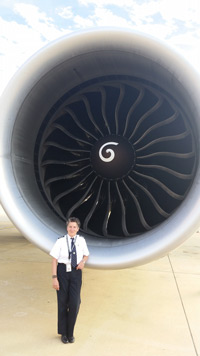 Capt. Renita Herrmann standing next to B-777 jet