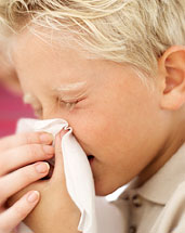 boy sneezing