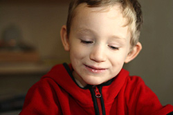 smiling boy in red shirt