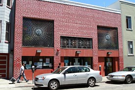 Mission Neighborhood Resource Center Clinic inside red brick building at 165 Capp Street in San Francisco