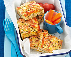 quiche cut into squares with a side of carrots