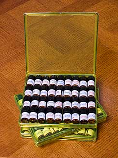 three small cases of homeopathic remedies on an oak table